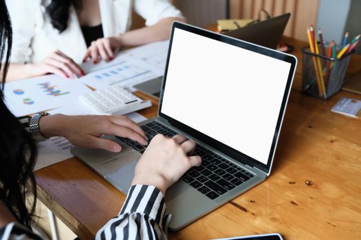 freelance concept, Woman using computers laptop on wooden desk blur background. Laptop computer with blank screen and can be add your texts or others on screen