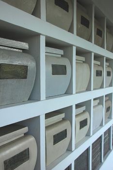 Urns with ashes in a columbarium wall