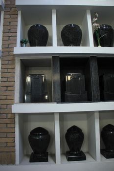 Urns with ashes in a columbarium wall