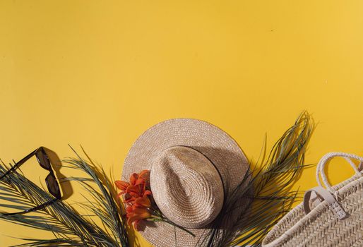 ummer background with straw hat and bag and palm leaves. High quality photo