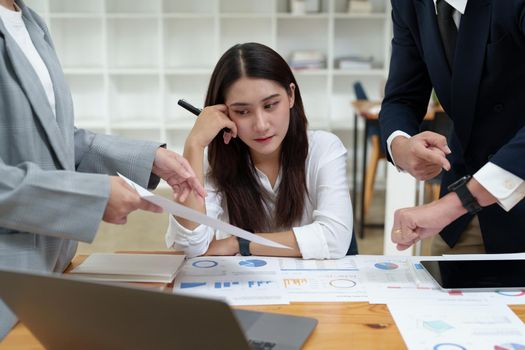 The portrait of an Asian female worker was warned by her supervisor as the profitability sales did not meet the planned targets.