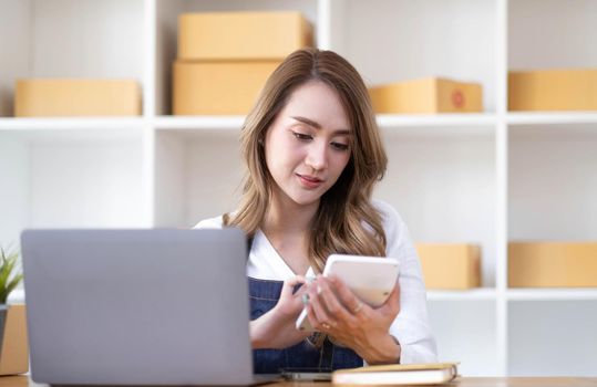 Starting small businesses SME owners female entrepreneurs Write the address on receipt box and check online orders to prepare to pack the boxes, sell to customers, sme business ideas online..