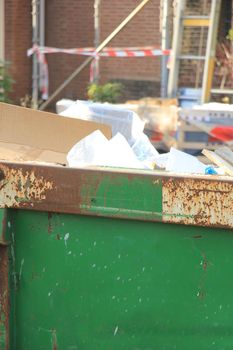 Loaded dumpster near a construction site, home renovation