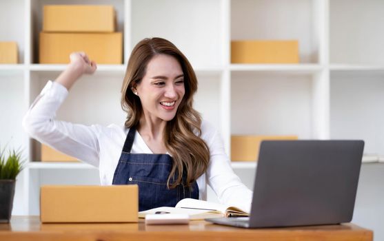 Portrait of Starting small businesses SME owners female entrepreneurs working on receipt box and check online orders to prepare to pack the boxes, sell to customers, SME business ideas online..