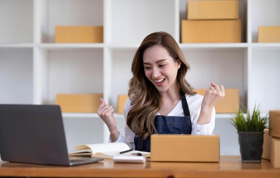 Portrait of Starting small businesses SME owners female entrepreneurs working on receipt box and check online orders to prepare to pack the boxes, sell to customers, SME business ideas online..