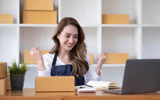 Portrait of Starting small businesses SME owners female entrepreneurs working on receipt box and check online orders to prepare to pack the boxes, sell to customers, SME business ideas online..