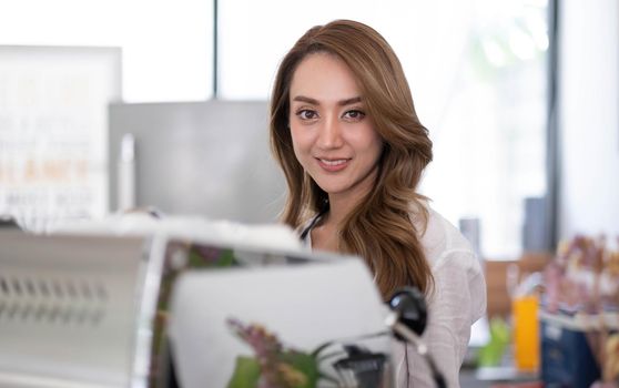 Startup successful small business owner sme beauty girl stand with tablet smartphone in coffee shop restaurant. Portrait of asian tan woman barista cafe owner. SME entrepreneur seller business concept.