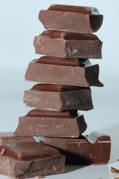 Dark chocolate bar , broken in oneven pieces
