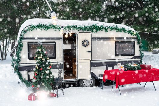 Modern campervan motorhome in winter camping decorated for Xmas or Happy New Year holiday