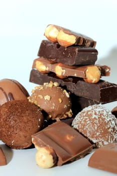 Different sorts of chocolates: bonbons and broken pieces of a chocolate bar