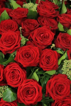 Big red roses in a wedding flower arrangement