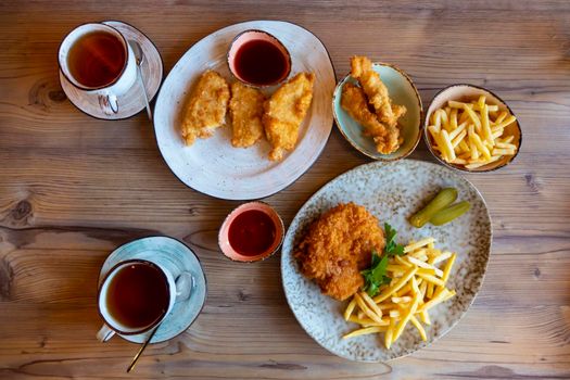 French fries with ketchup on wooden background. High quality photo