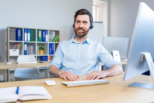 Portrait of a happy businessman, man working remotely, using a headset for a video call