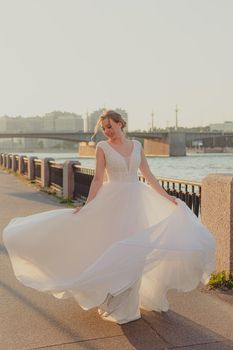 The bride is spinning in her wedding dress. Wedding article. Happy bride. Love. Photos for printed products. Romance. Wedding catalog