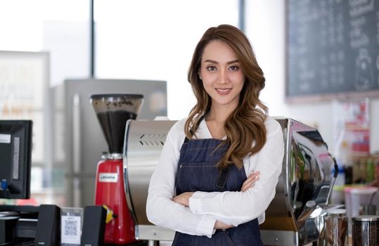 Startup successful small business owner sme beauty girl stand with tablet smartphone in coffee shop restaurant. Portrait of asian tan woman barista cafe owner. SME entrepreneur seller business concept.