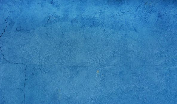 Abstract blue texture background. Surface of old damaged blue plaster.