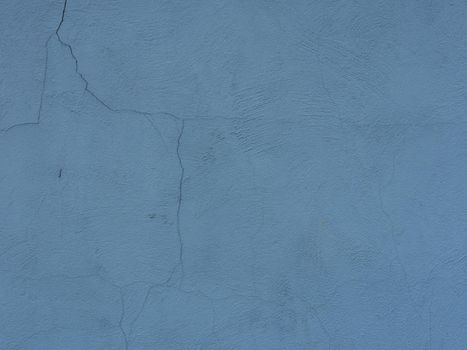 Abstract background of blue old shabby cracked plaster.