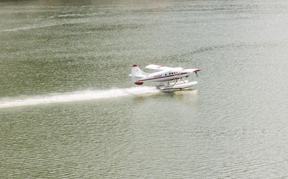 Juneau, AK - 9 June 2022: Wings Air seaplane taking off in the harbor of Juneau