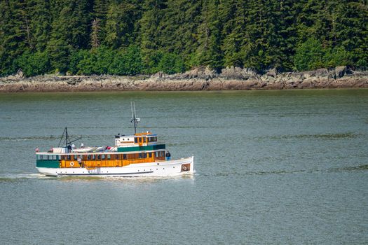Juneau, AK - 9 June 2022: View of the the MV Discovery historic yacht cruising from Juneau