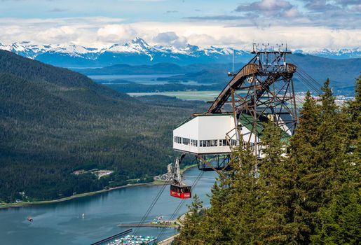 Juneau, AK - 9 June 2022: Passengers arriving at the mountain in the red cable car car of Goldbelt tram