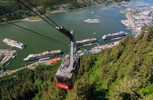 Juneau, AK - 9 June 2022: Passengers arriving at the mountain in the red cable car car of Goldbelt tram