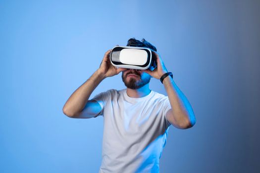 Closeup portrait of a man wearing VR goggles, working over virtual project, enjoying new reality, playing video game. Technology, innovation gadgets