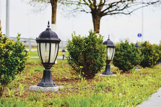 a device for giving light, either one consisting of an electric bulb together with its holder and shade or cover, or one burning gas or a liquid fuel.Street lighting.lamp