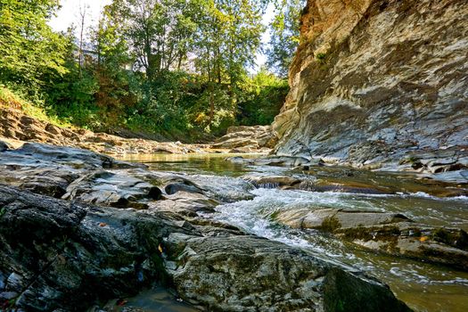 a large natural stream of water flowing in a channel to the sea, a lake, or another such stream.