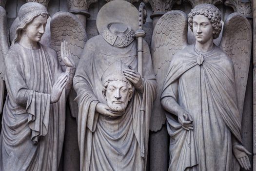Saint Denis without head and angel, Notre dame , Paris, France