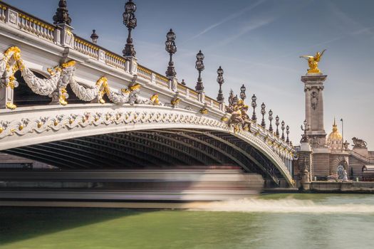 Line of Street lights and Invalides dome in Pont Alexandre III, Paris, france
