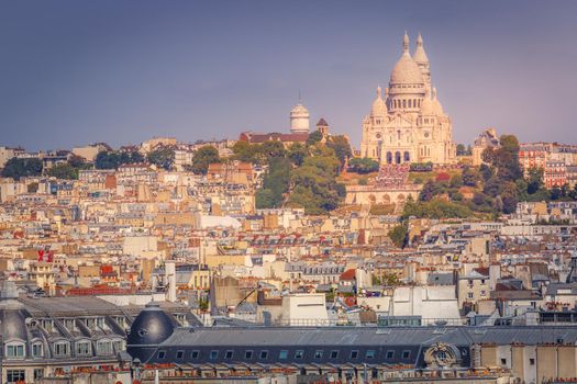 Parisian roofs of Montmartre and Sacre Couer at sunset Paris, France