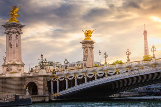 Eiffel Tower and Pont Alexandre III at dramatic golden sunset, Paris, france