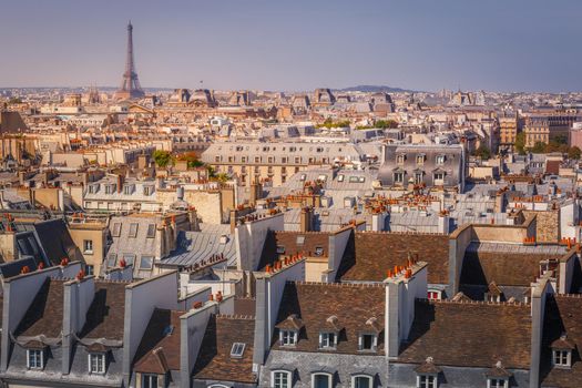 Eiffel tower and parisian roofs at sunrise Paris, France