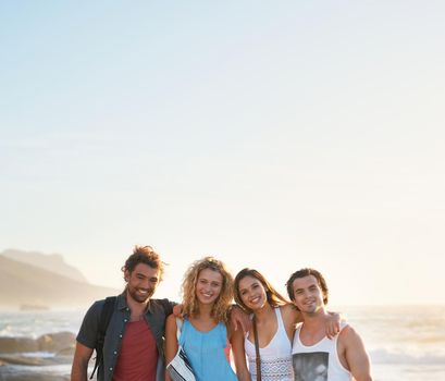 group of friends posing on beach having fun summer vacation lifestyle on seaside at sunset.