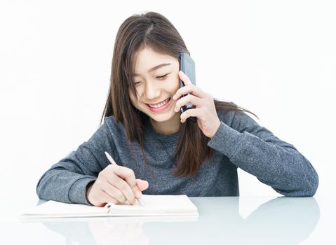 Woman long hair Woman using mobile phone and  writing notebook on white background