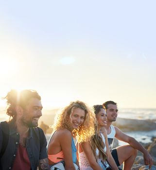 group of friends on beach enjoying summer holiday students having fun vacation hanging out on beachfront at sunset.