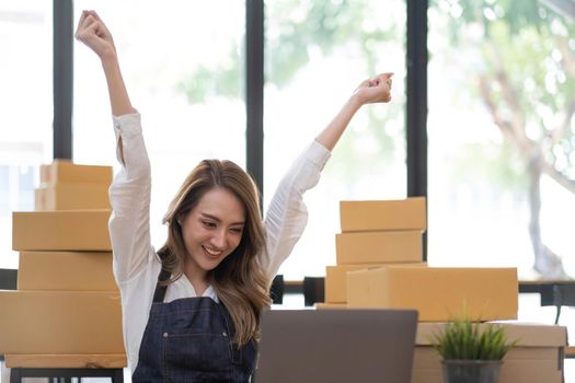 Portrait of Starting small businesses SME owners female entrepreneurs working on receipt box and check online orders to prepare to pack the boxes, sell to customers, SME business ideas online..