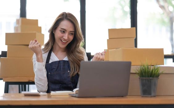 Portrait of Starting small businesses SME owners female entrepreneurs working on receipt box and check online orders to prepare to pack the boxes, sell to customers, SME business ideas online..