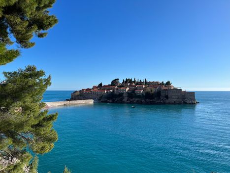 Sveti Stefan island against the blue sky and the sea. Montenegro. High quality photo