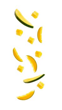 falling mangoes isolated on a white background with a clipping path. cubes of fruit in the air. Fruit levitation