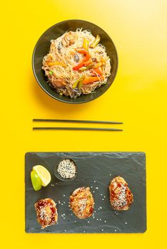 food Asian cuisine. Asian or Szechuan noodles. Chinese wok noodles in a bowl with vegetables and teriyaki chicken.