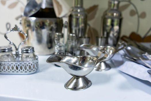 A set of various cutlery and objects. A variety of shiny metal cutlery.