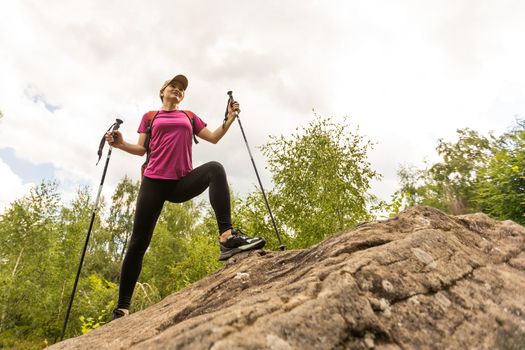 woman holding sticks and walking on fresh air.