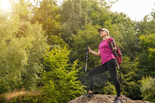 woman holding sticks and walking on fresh air.