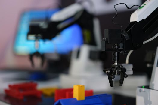Mechanical robotic hand manipulator in industrial production. Robotic arm in factory concept