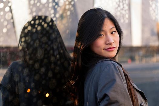 portrait of a young beautiful asian woman with a happy and cool smile on face, copy space for text