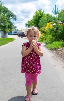 The child eats ice cream on the street. Selective focus. Food.