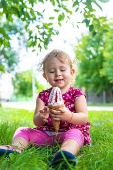 The child eats ice cream on the street. Selective focus. Food.