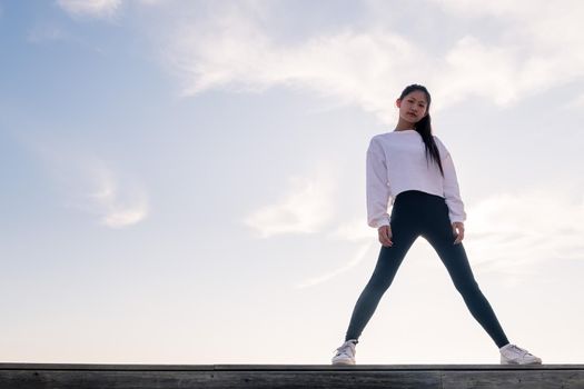 powerful asian sportswoman posing confident looking defiant at camera, concept of sport and healthy lifestyle, copyspace for text