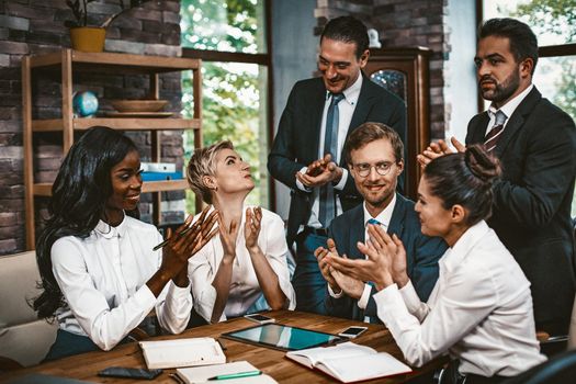 Cheering Of Business Team At Meeting, Cheerful Group Of Businesspeople Their Hands Together Sitting At Desk Multi-Ethnic Group Of Coworkers Applauding Each Other, Toned Image